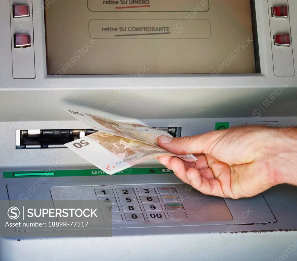 Customer Withdrawing Money From A Bank Cash Point Machine, Torremolinos Malaga Andalusia Spain