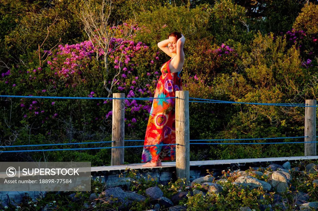 A Woman Basks In The Warm Sun While Standing On A Bridge In Parknasilla, County Kerry Ireland