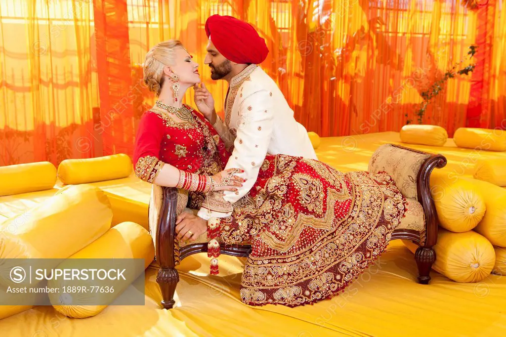 A bride and groom in traditional indian dress for their wedding ceremony, ludhiana punjab india