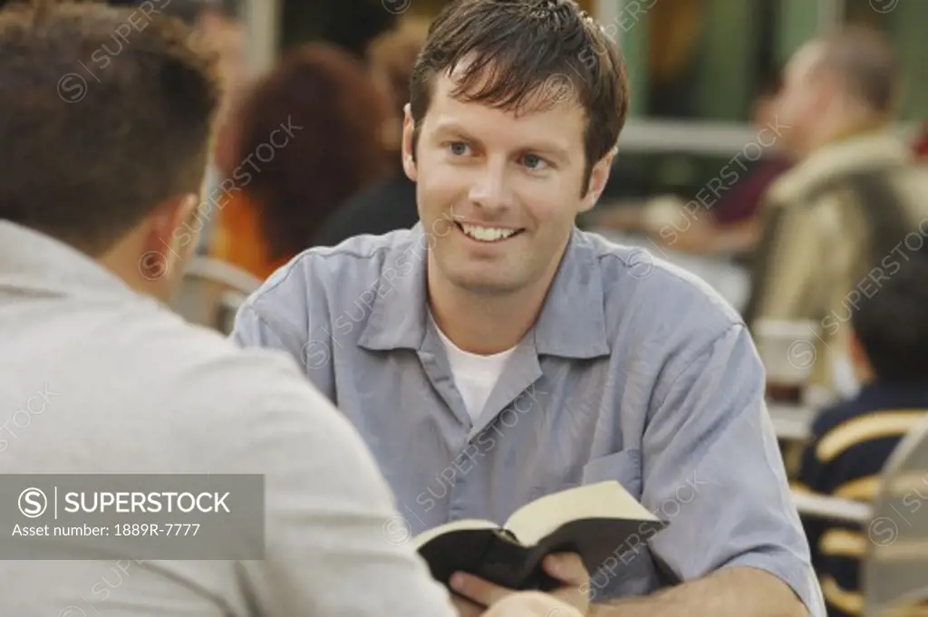 Man sharing from a book