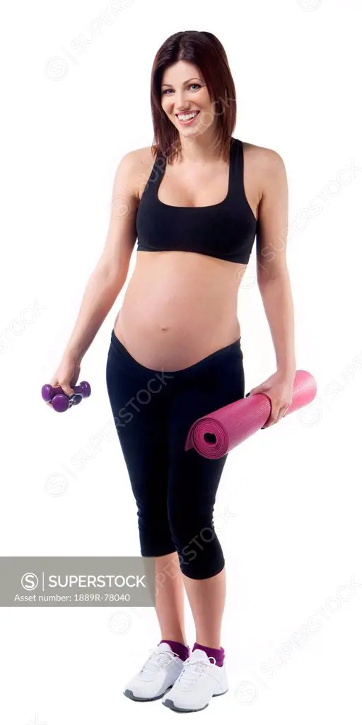 A pregnant woman with her exercise mat and dumbbells, edmonton alberta canada