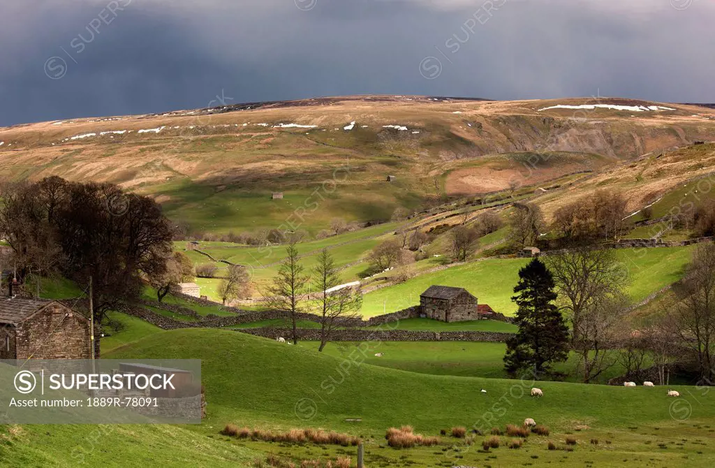 Storm clouds over rolling hills, swaledale england