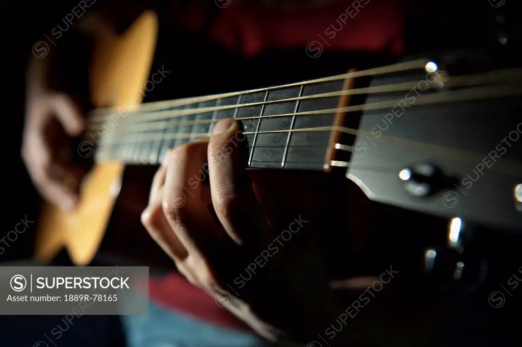 Playing a guitar, edmonton alberta canada