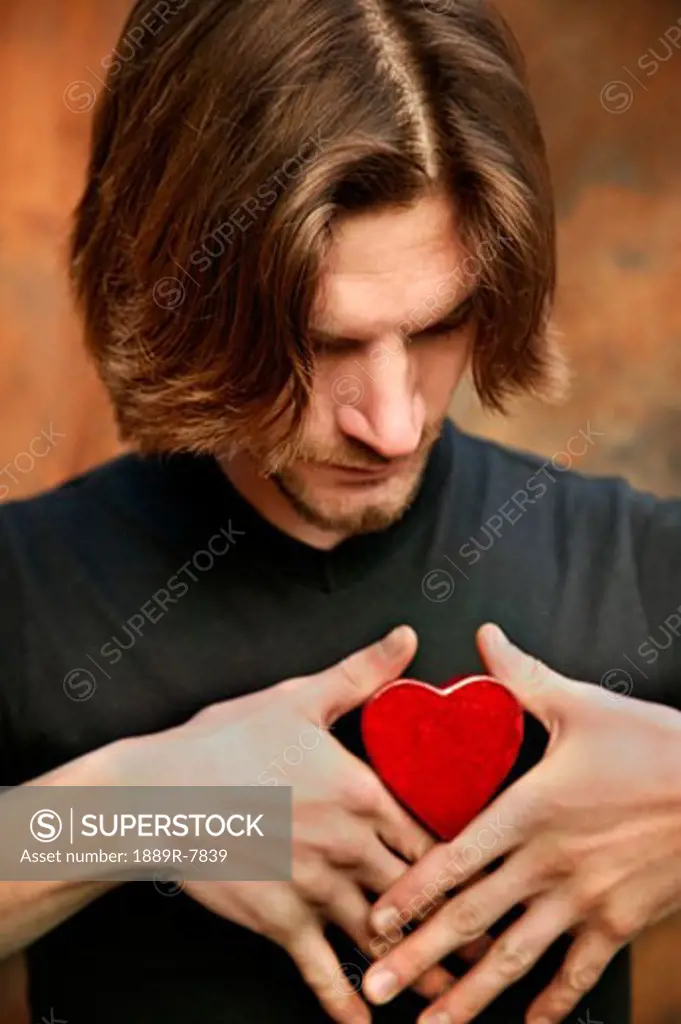 Man holding heart on his chest