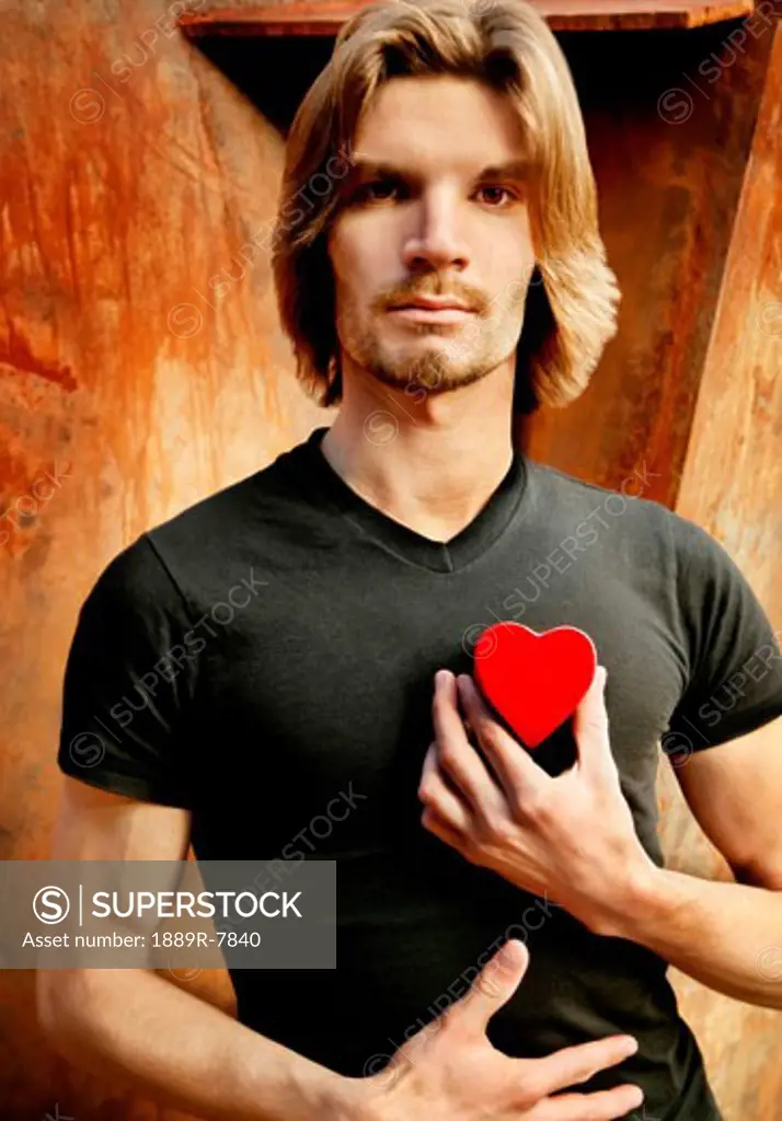 Man holding heart to his chest