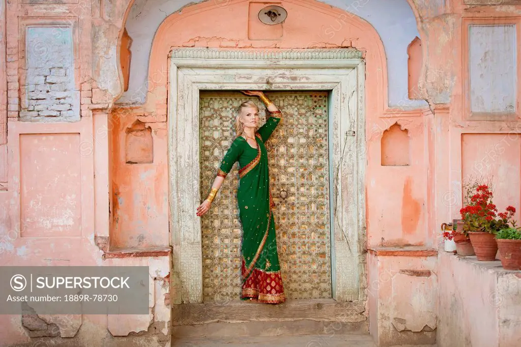A woman posing in a doorway wearing a sari, ludhiana punjab india