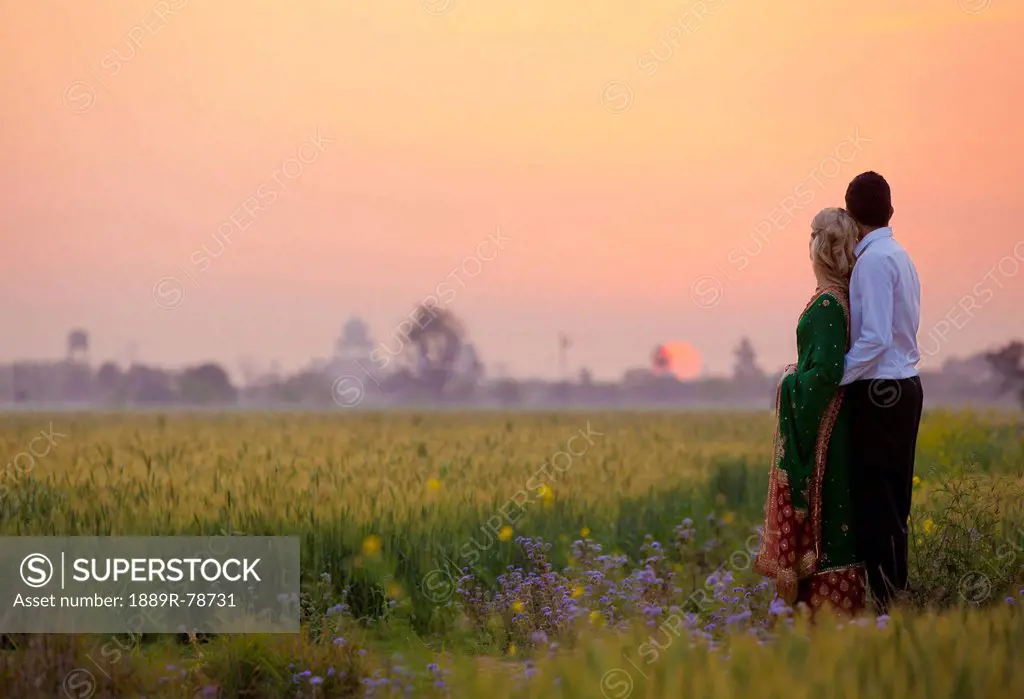 A couple standing together in a field at sunset, ludhiana punjab india