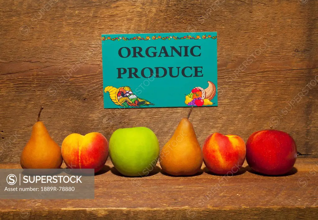 Variety Of Fruit In A Row On A Wooden Shelf With An Organic Produce Sign, Waterloo Quebec Canada