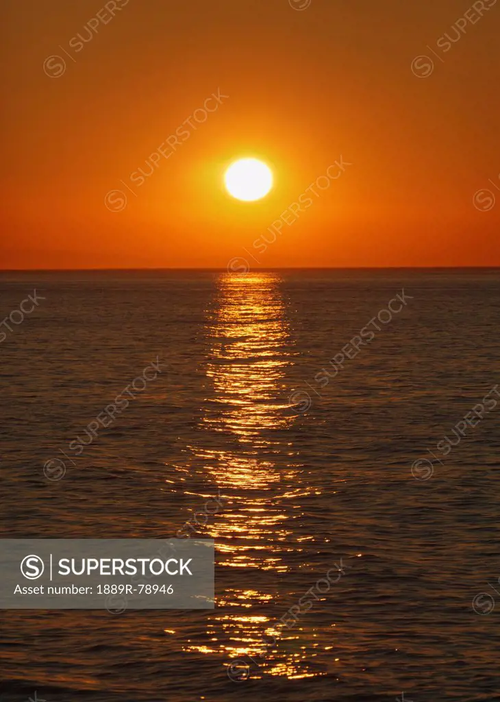 sunrise over malaga bay seen from torremolinos, torremolinos, costa del sol, malaga province, spain