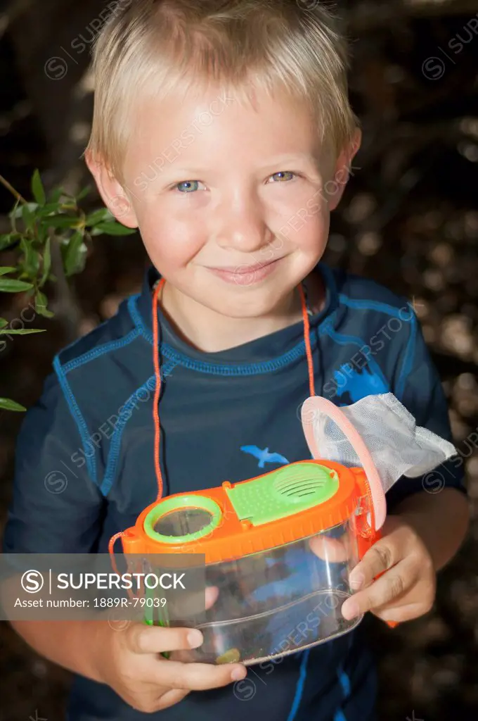 A young boy with a bug catcher, lake tahoe california united states of america