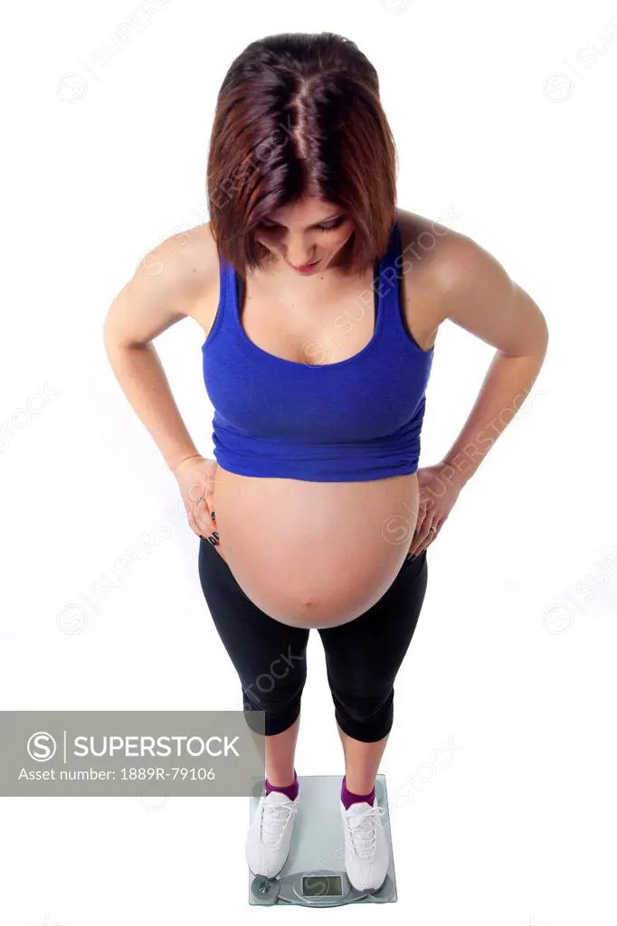 A pregnant woman stands on a scale, edmonton alberta canada