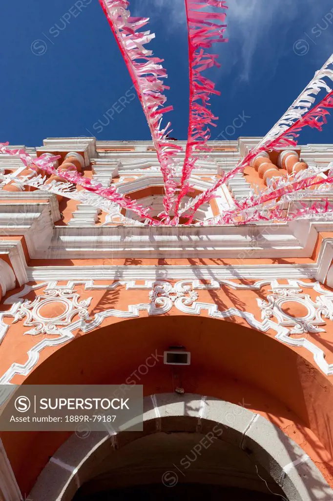 Red and white streamers hung over an arched doorway, guatemala city guatemala