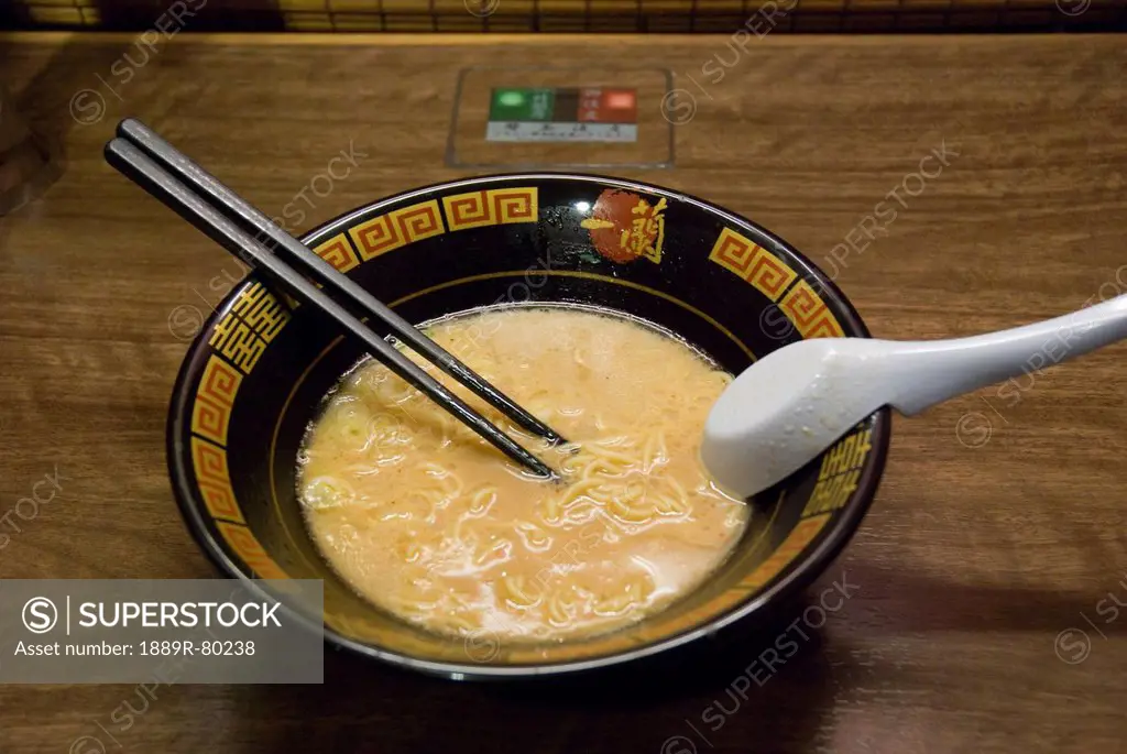 Black bowl of japanese noodles on a wooden table, kyoto, japan