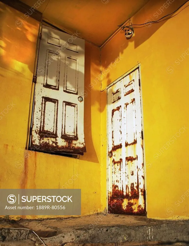 Two rusted doors on different levels, cane garden bay tortula british virgin islands