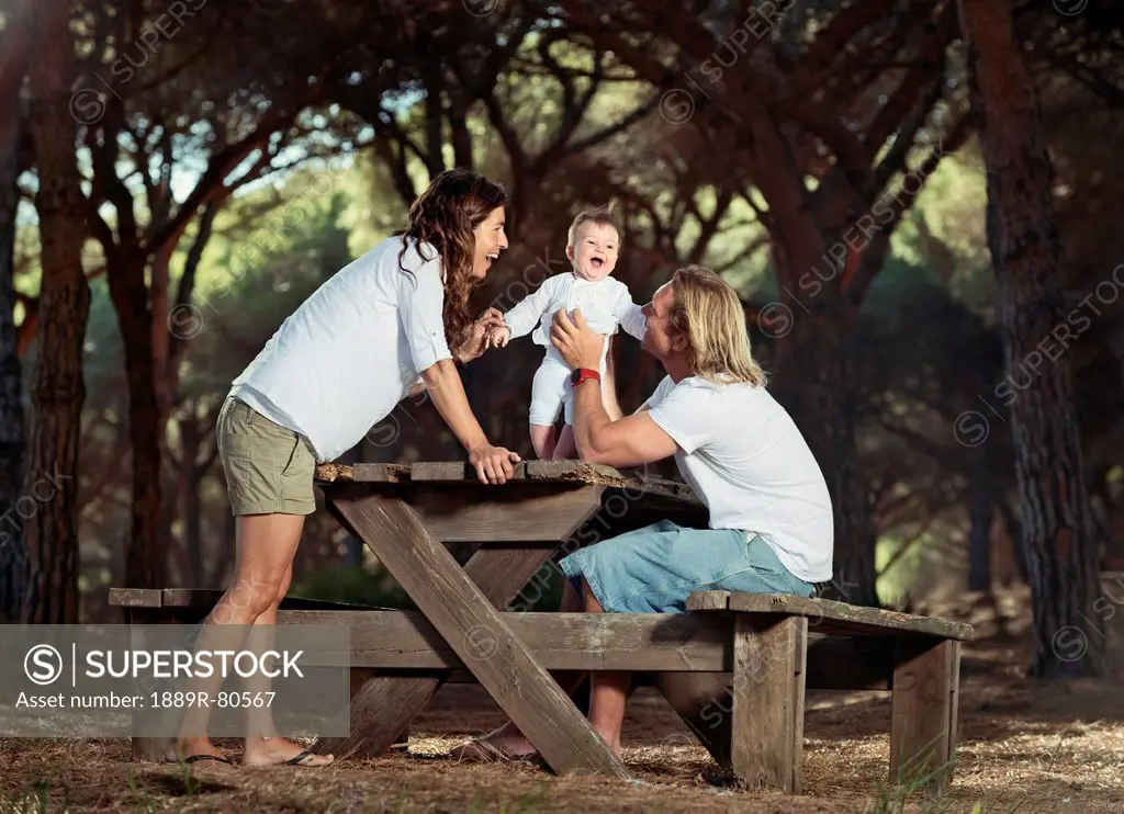 A family with a baby at a picnic table, tarifa cadiz andalusia spain