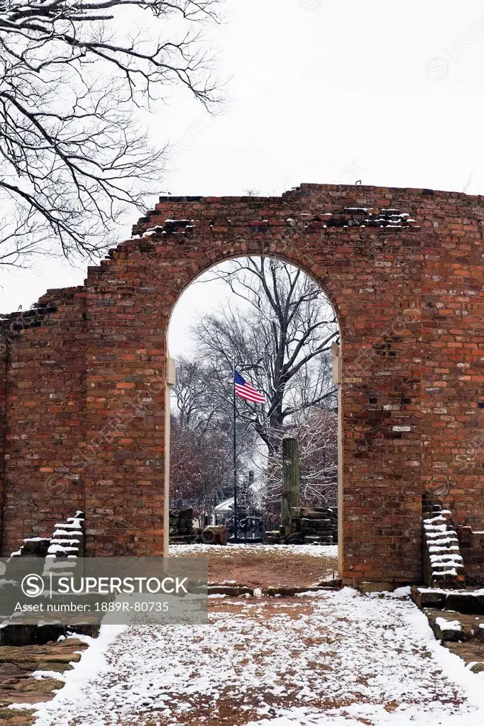 American flag flying through the archway of the ruins of a brick wall, tuscaloosa alabama united states of america