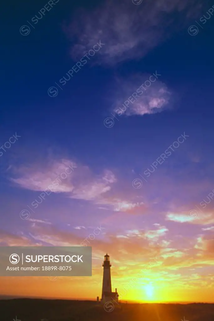 Sunset behind Yaquina Head Lighthouse, Yaquina Bay