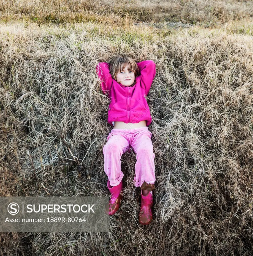 A young girl wearing pink laying on the grass, queensland gold coast australia