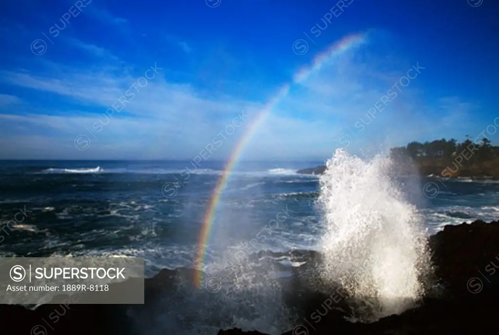 Half-arc rainbow over crashing wave, Defoe Bay, Pacific coast