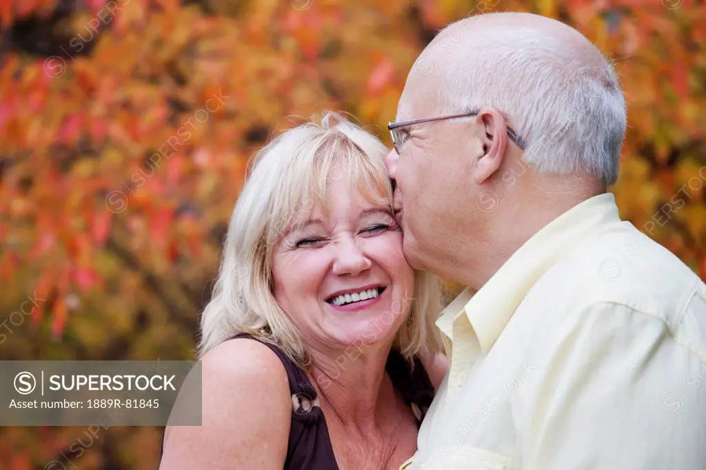 Mature married couple enjoying spending time together in park during fall season, edmonton, alberta, canada