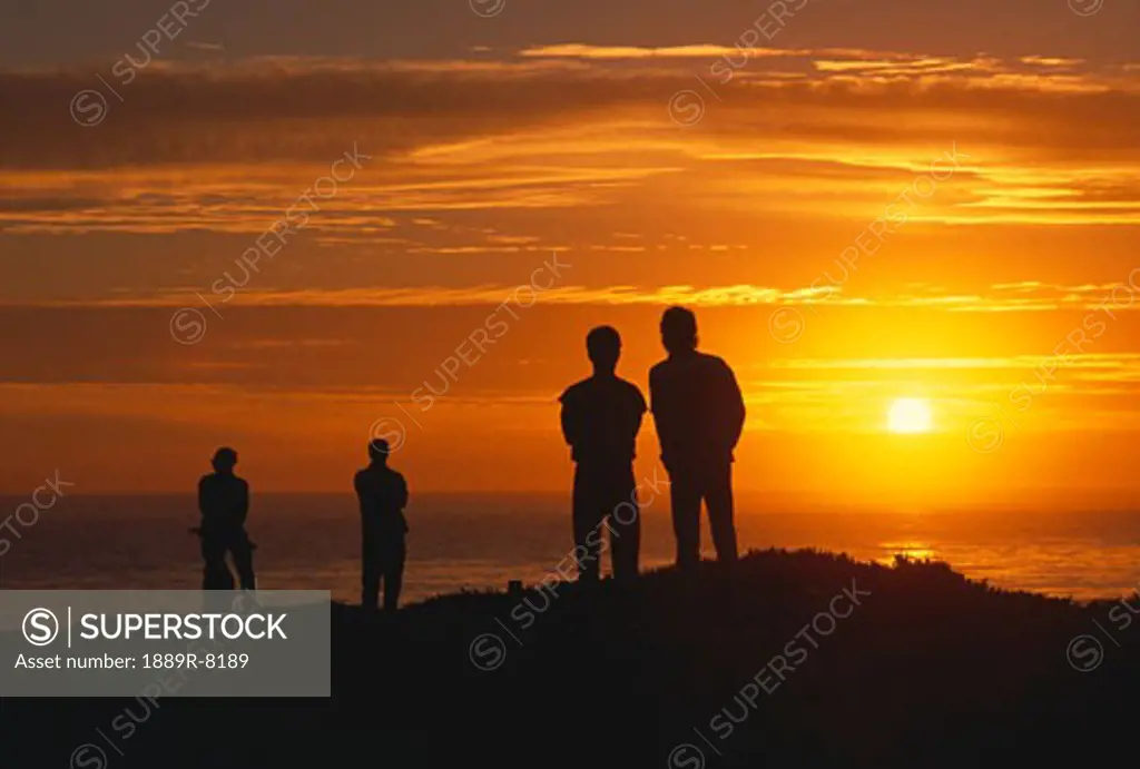 Silhouetted figures in sunset