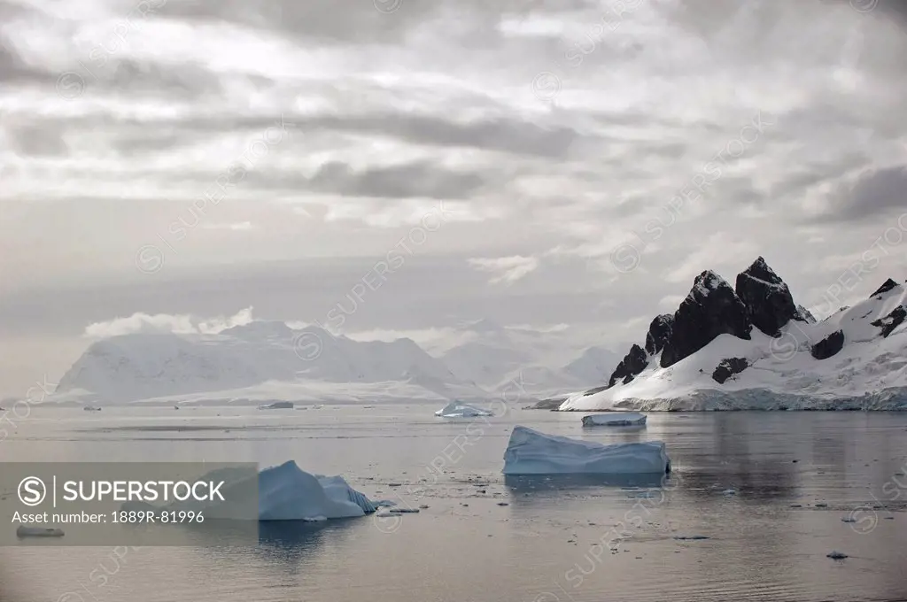 Icebergs and mountains along the coastline, antarctica