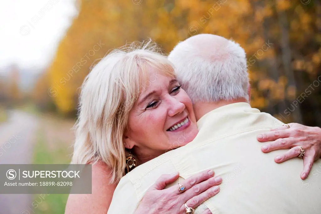 Mature married couple enjoying spending time together in park during fall season, edmonton, alberta, canada
