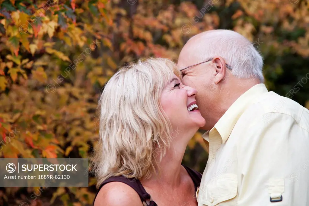 Mature married couple spending time together in a park in autumn, edmonton, alberta, canada