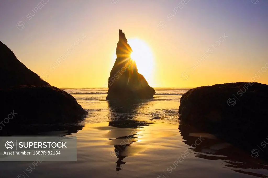 Rock formations at low tide on bandon beach at sunset, oregon, united states of america
