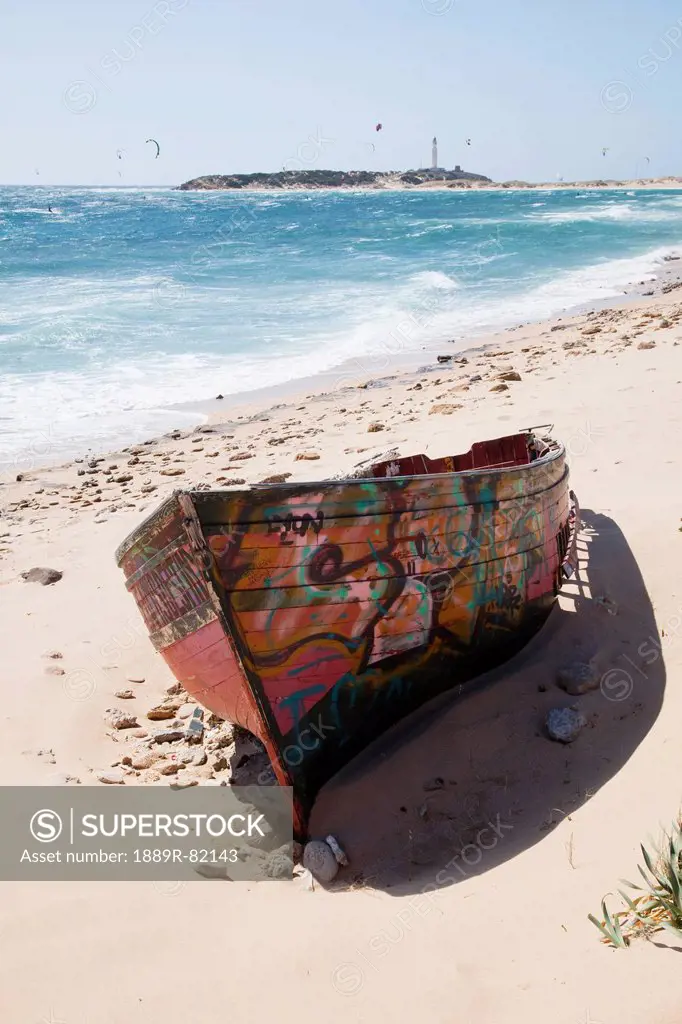 A hand painted wooden boat on zahora beach, andalusia, spain