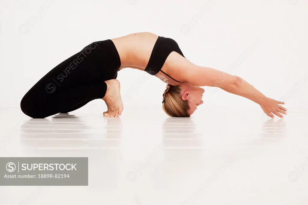 A woman in a yoga pose, tarifa, cadiz, andalusia, spain