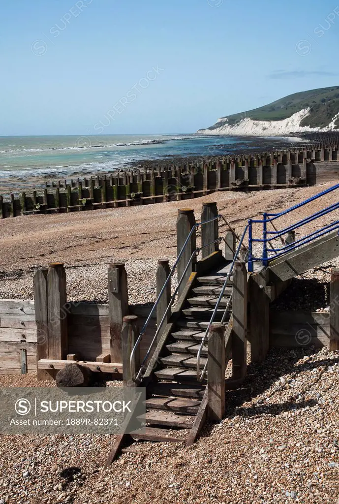Wooden steps, groynes and pebble beach, sussex, england