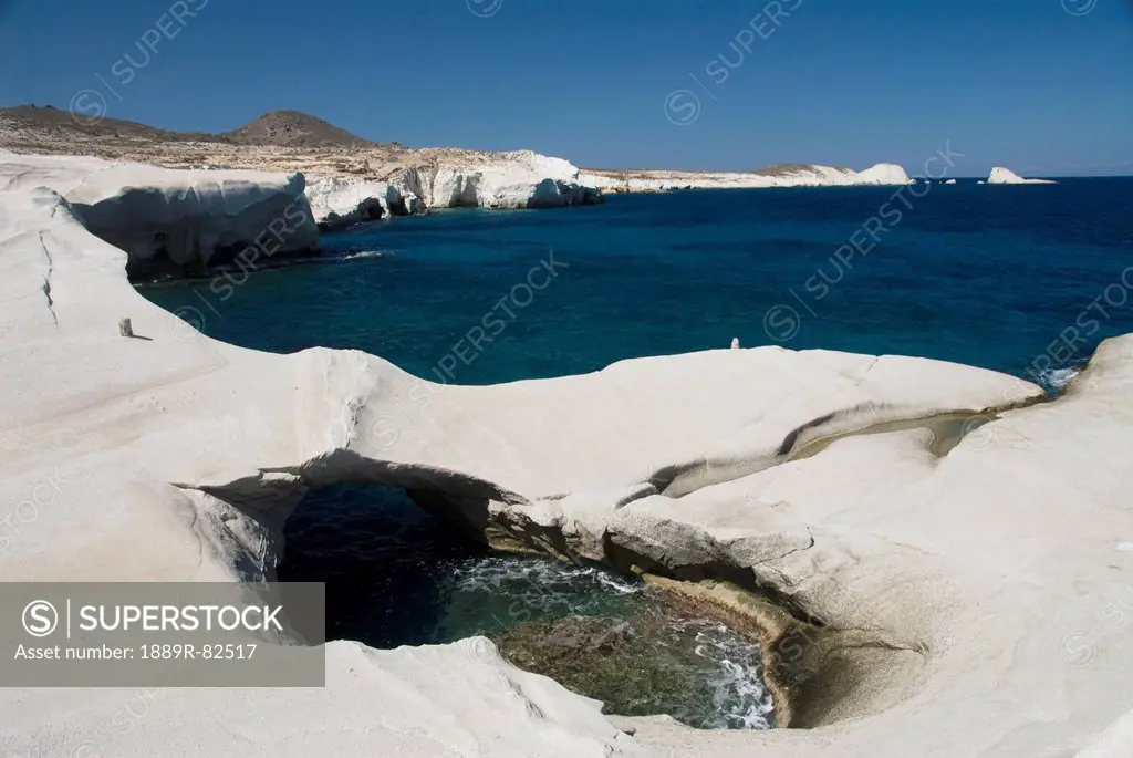 Pool of water and unique rock formations along the coast, sarakiniko, island of milos, greece