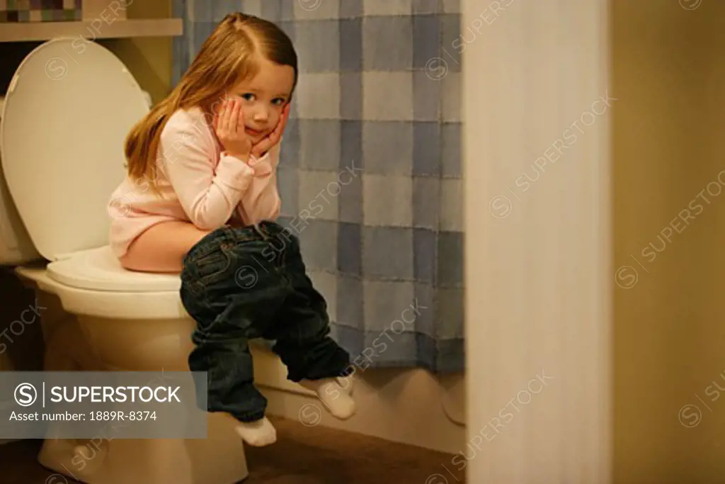 Child sits on the potty