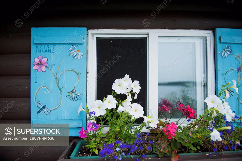 Cabin window with a window flower pot underneath, kenora ontario canada