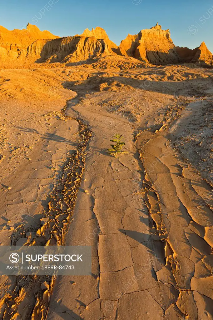 A dry stream bed leads into distance towards the eroded formations in badlands national park, south dakota united states of america