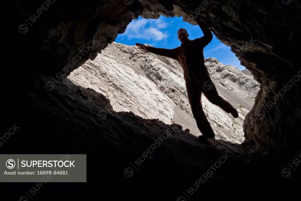 Man posing in a cave entrance, coleman alberta canada