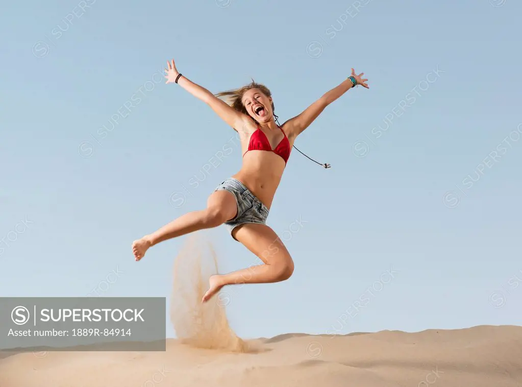 A girl jumping on the beach, tarifa cadiz andalusia spain