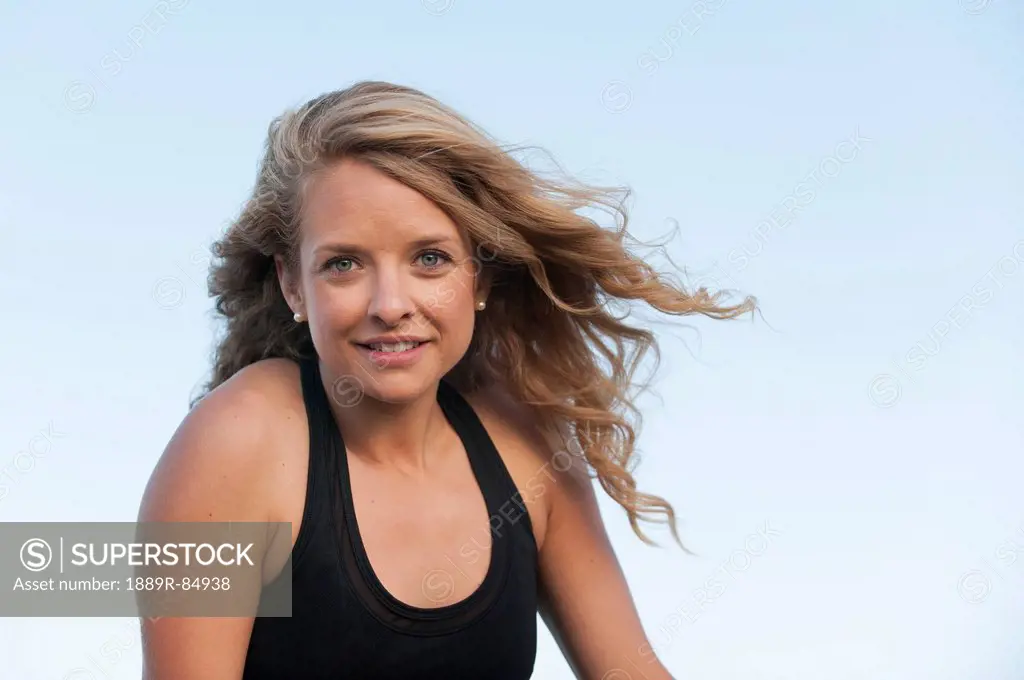 Portrait of a woman with long blond hair against a blue sky, arvada colorado united states of america