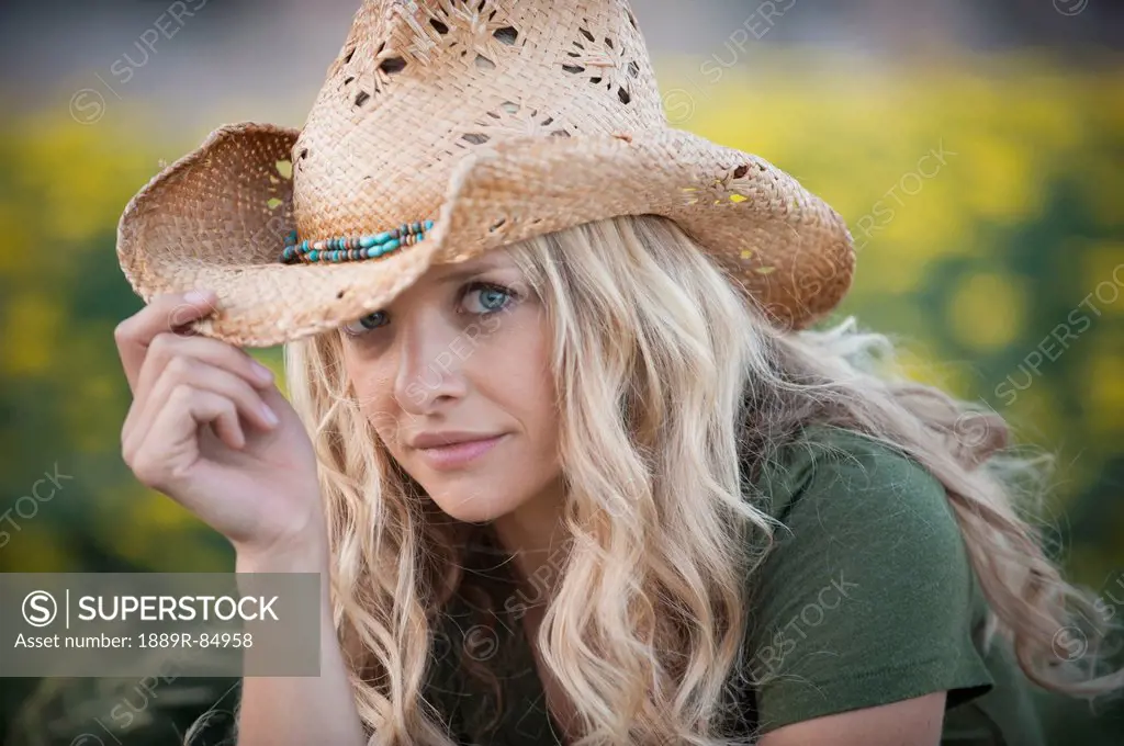 Portrait of a woman with long blond hair wearing a cowboy hat, arvada colorado united states of america