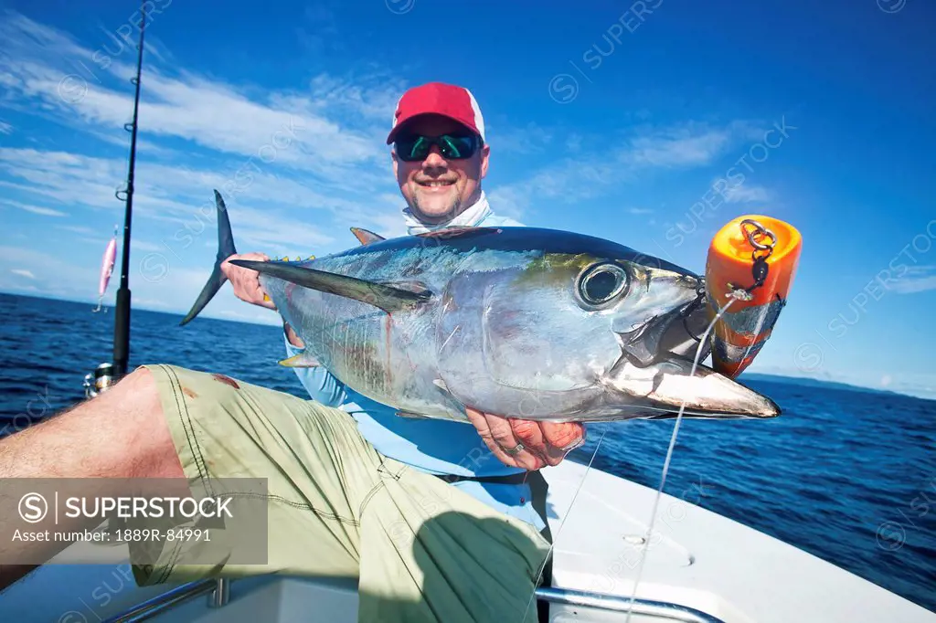 Man holds a fresh caught yellowfin tuna, panama