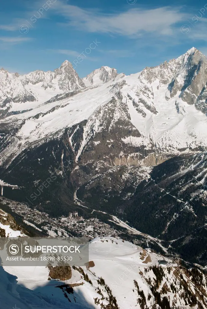 Rugged Snow Covered Mountain Range With A City In The Valley, Chamonix_Mont_Blanc Rhone_Alpes France