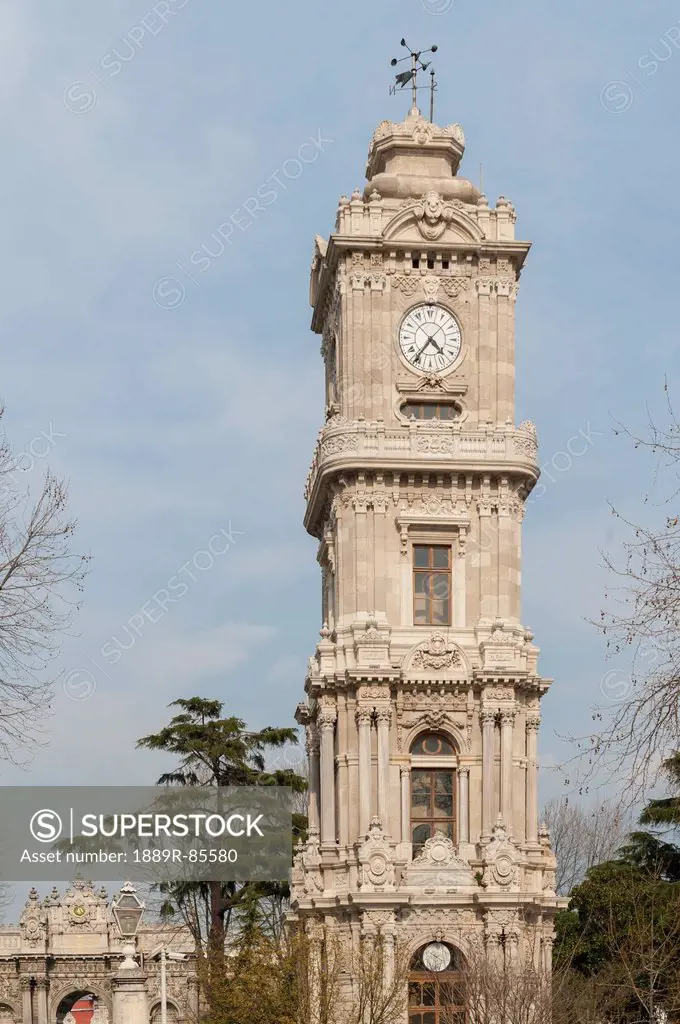 Clock Tower Of The Dolmabahce Palace Against A Blue Sky, Istanbul Turkey