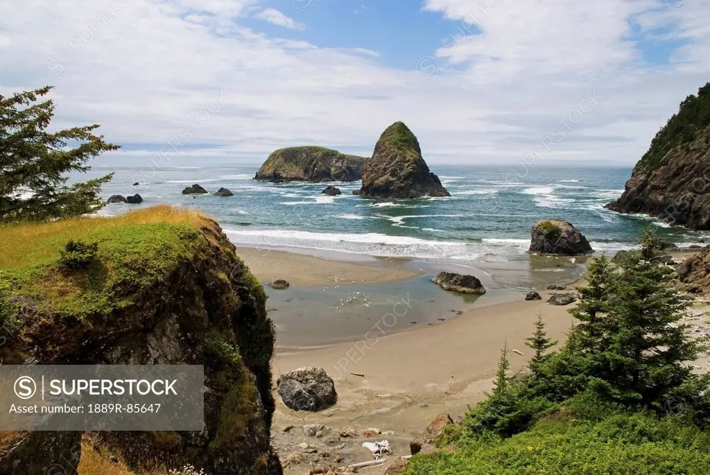 Rock Formations In The Water And Beach Along The Oregon Coast, Oregon United States Of America
