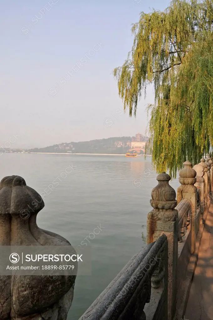 A Tree And Ornate Balusters On A Railing On The Water´s Edge, Beijing China