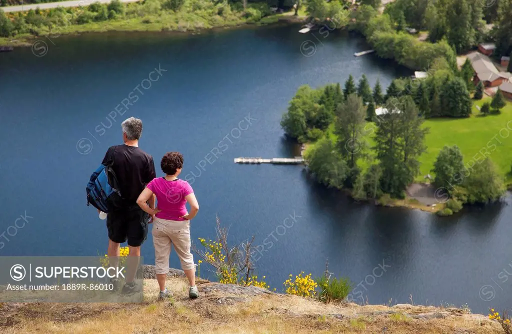 A Senior Couple Overlook Cowichan Lake On Vancouver Island, British Columbia Canada