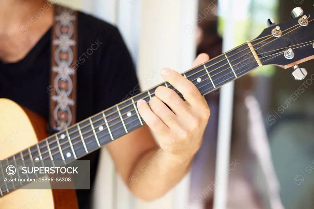 A Man Playing His Guitar;Wailua Kauai Hawaii United States Of America