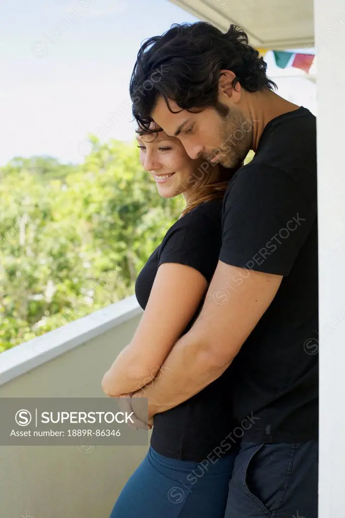 A Man And Woman Standing Close Together On A Balcony;Wailua Kauai Hawaii United States Of America