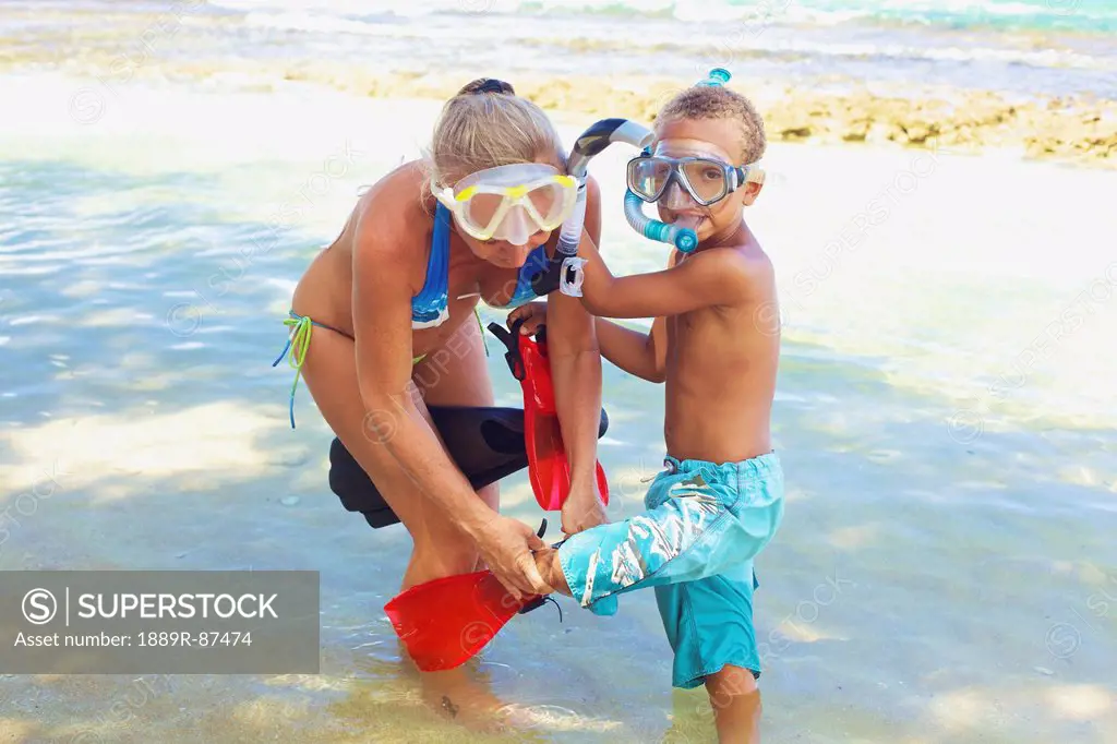 A Mother And Son With Snorkelling Gear In The Shallow Water;Hawaii United States Of America
