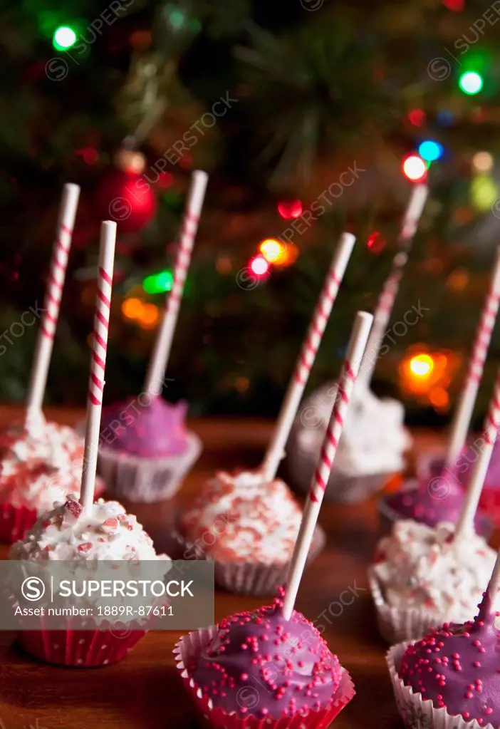 Decorated Pink Cake Pops In Front Of A Christmas Tree;Edmonton Alberta Canada